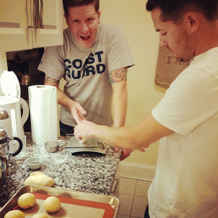 Here the Chef shows a fellow Coastie how to weigh each piece of dough, so each is the same.  